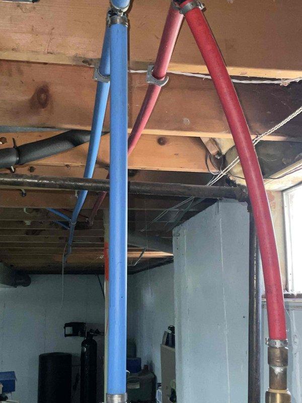 Provided comprehensive estimate for tankless water heater installation in basement utility area where existing standard tank water heater system was non-operational. Assessed current plumbing infrastructure including supply lines with significant mineral buildup visible in piping, evaluated existing pipe routing with insulated hot and cold water lines, and determined requirements for new tankless unit installation including necessary venting, gas line modifications, and electrical connections. Documented existing conditions showing heavy scale deposits in current system and recommended tankless solution as upgrade from previously quoted 40 and 50 gallon standard tank options.