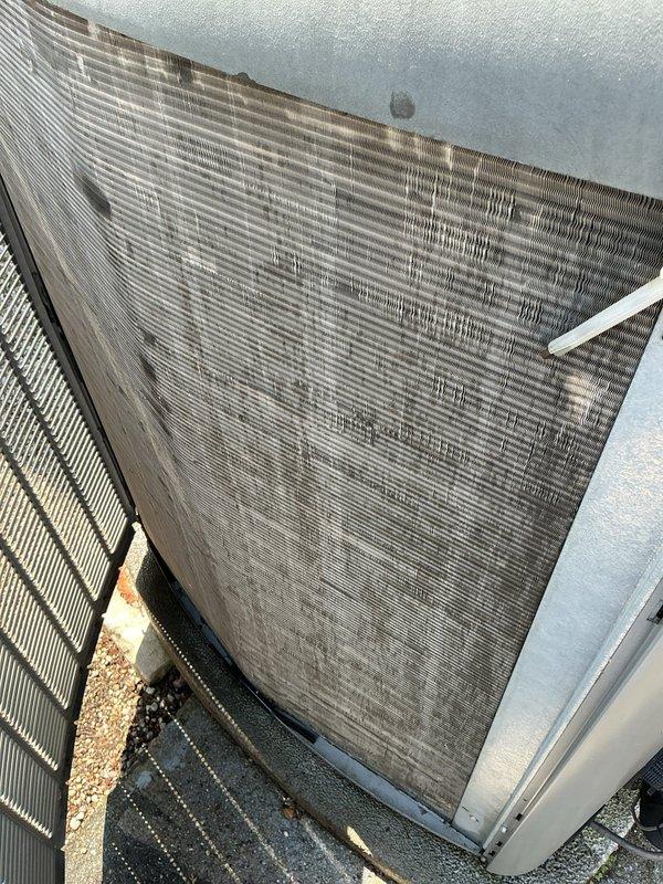 Completed annual preventive maintenance on Lennox rooftop air conditioning unit. Performed comprehensive inspection of condenser coils, which showed significant accumulation of dust and outdoor debris on protective grilles and fin surfaces. Documented equipment condition through photographic records showing dirt buildup on coil fins and metal housing components requiring attention during next service interval.