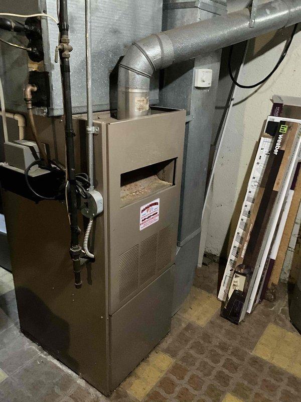 Conducted on-site evaluation of 30-year-old furnace and air conditioning system for replacement estimate at owner-occupied single-family residence. Assessed existing split system configuration including basement-mounted furnace with horizontal ductwork, Aprilaire humidifier integration, and associated copper plumbing connections. Documented current equipment condition, ductwork layout, and utility room infrastructure through photographic documentation to provide accurate replacement system specifications and installation requirements.