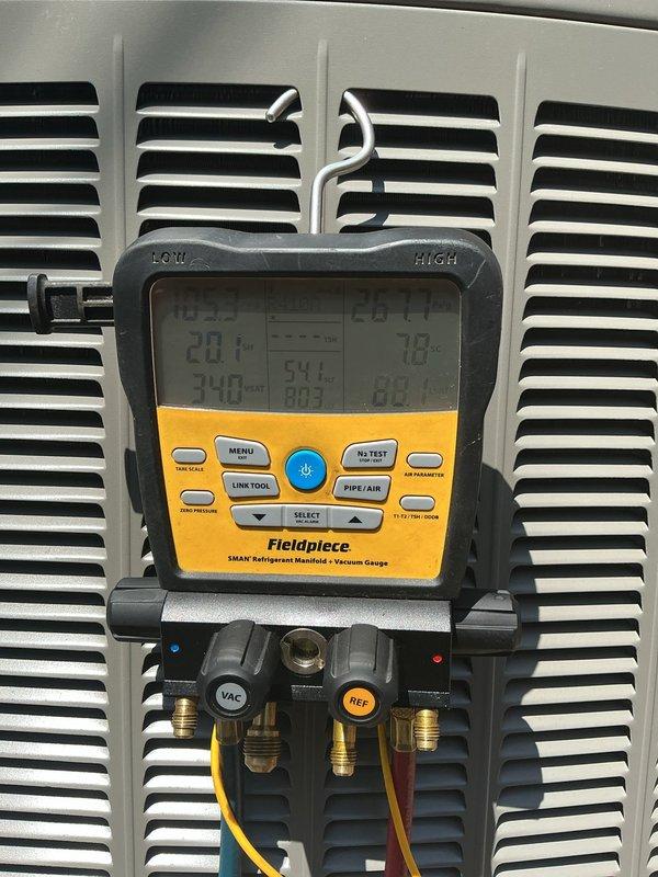 Completed annual preventative maintenance on residential split system air conditioning unit. Performed comprehensive inspection of outdoor condenser unit including visual assessment of cabinet condition, coil cleanliness, and electrical connections. Utilized Fieldpiece SMAN refrigerant manifold to verify system pressures and refrigerant charge levels, confirming proper operating temperatures and superheat/subcooling values within manufacturer specifications. All components found operating normally with no deficiencies noted during inspection.