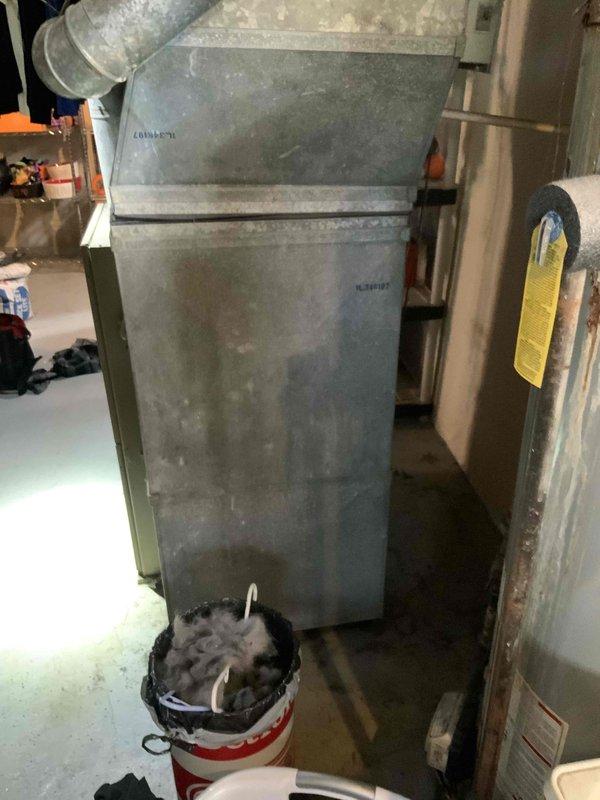 Completed HVAC system replacement estimate for a small to mid-sized residential property requiring both heating and cooling equipment. Assessed existing basement-mounted natural gas furnace showing significant age and wear, along with exterior air conditioning unit positioned on concrete pad adjacent to propane tank. Provided comprehensive quote for complete system replacement including new furnace installation in basement location and compatible outdoor condensing unit sized appropriately for 0-1200 square foot application.