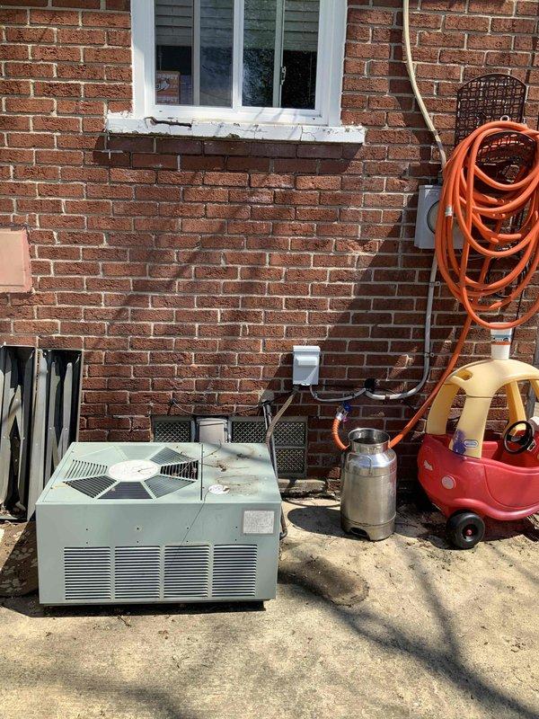 Completed HVAC system replacement estimate for a small to mid-sized residential property requiring both heating and cooling equipment. Assessed existing basement-mounted natural gas furnace showing significant age and wear, along with exterior air conditioning unit positioned on concrete pad adjacent to propane tank. Provided comprehensive quote for complete system replacement including new furnace installation in basement location and compatible outdoor condensing unit sized appropriately for 0-1200 square foot application.