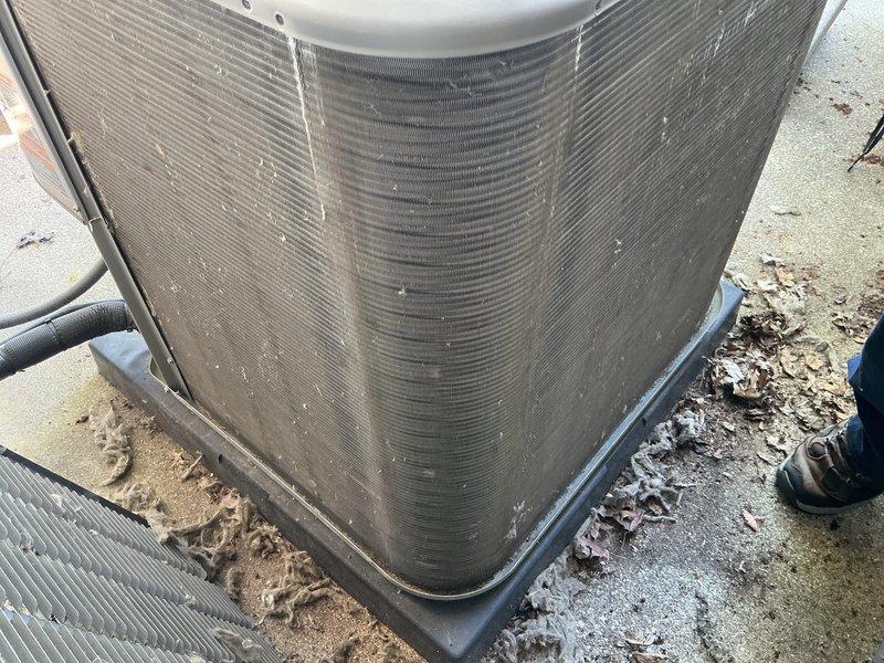 Completed annual cooling maintenance on residential split system. Performed comprehensive inspection of outdoor condenser unit, cleaned debris and organic matter from base and coil fins, replaced air filter and evaporative cooling pad as needed, and verified proper system operation with all components functioning within normal parameters.
