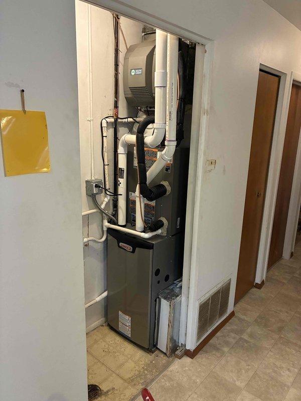 Completed full HVAC system installation including a 70,000 BTU furnace with humidifier and 3-ton air conditioning unit with rear discharge configuration. Installed furnace in interior utility closet with proper PVC venting and ductwork connections, mounted AC condenser on exterior concrete pad with electrical disconnect and conduit properly secured to building exterior. Obtained mechanical and electrical permits, reconnected all system components, and verified proper operation of complete heating and cooling system.