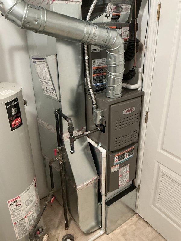 Completed full HVAC system installation including a Lennox 70,000 BTU furnace and 2-ton air conditioning unit with rear discharge configuration. Installed furnace in interior utility closet with proper ductwork connections, flexible conduit, and copper refrigerant lines with insulation. Mounted AC condenser unit outdoors on concrete pad with rubber isolation mounts and completed all electrical connections including disconnect box and conduit runs. Verified all mechanical and electrical connections, reconnected system components, installed safety shut-off valves on gas lines, and ensured proper clearances for all equipment. System tested and operational upon completion.