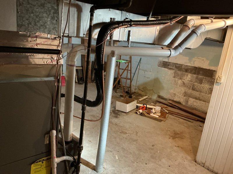 Completed full HVAC system installation including 70,000 BTU gas furnace with liner and humidifier in basement location, and 2-ton air conditioning condenser unit with rear discharge configuration at exterior of residence. Installed all necessary ductwork connections, electrical disconnects, and refrigerant line sets, then reconnected existing system components to new equipment and verified proper operation of complete heating and cooling system.