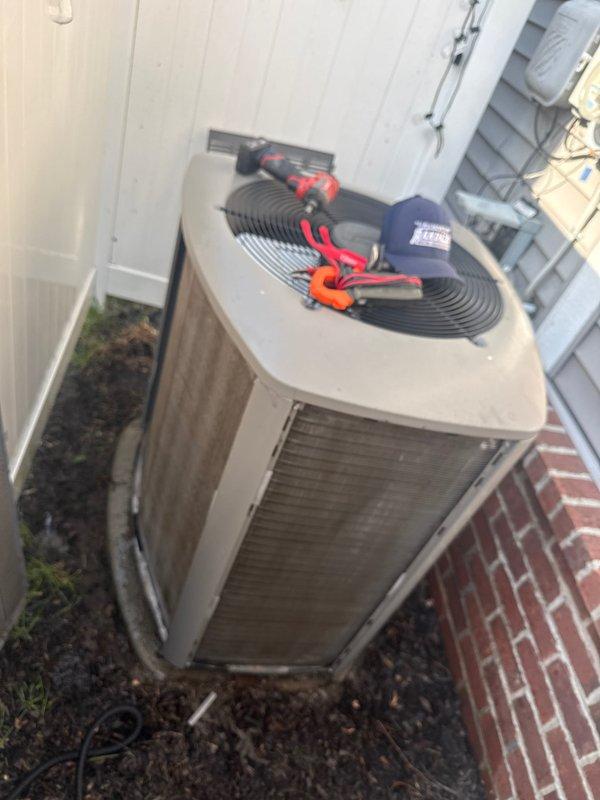 Completed routine AC tune-up on 5-year-old residential air conditioning system. Performed comprehensive maintenance including electrical testing with multimeter, inspected condenser unit exterior condition, verified fan operation and protective grille integrity, and assessed refrigerant lines and condensate drainage. System operating within normal parameters with no deficiencies identified requiring immediate attention.