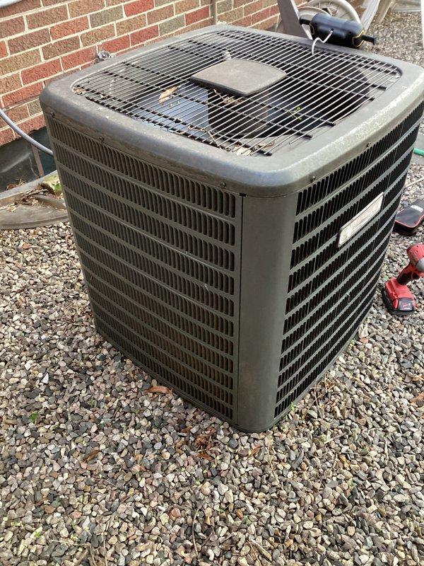# HVAC Maintenance - ACM Completed

Performed routine air conditioning maintenance on residential outdoor condenser unit. Conducted comprehensive visual inspection of equipment, documenting current condition with photographs. Unit operational with notable dirt and grime accumulation on exterior surfaces, grilles, and protective guards consistent with normal outdoor exposure. Condenser positioned on gravel pad against brick exterior wall with adequate clearance for airflow. All protective guards and louvered panels intact. Equipment functional with no immediate service concerns identified during this maintenance visit.