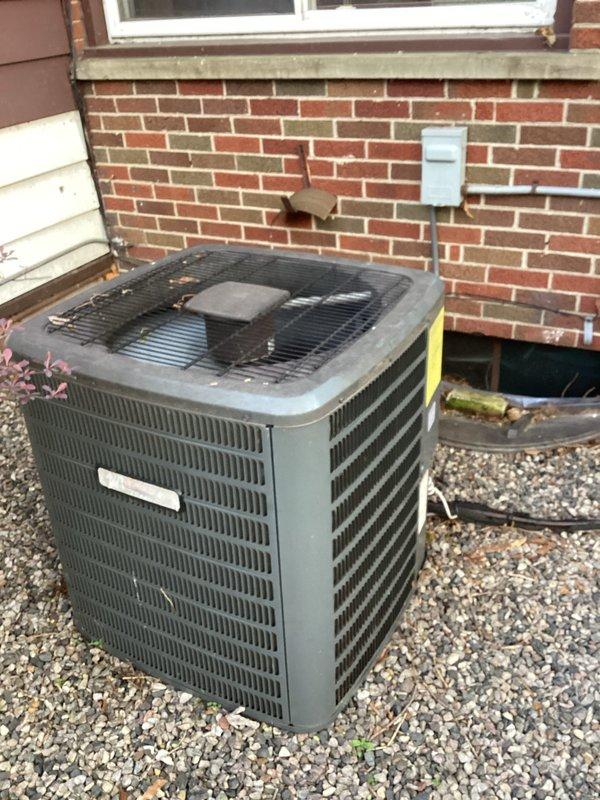 # HVAC Maintenance - ACM Completed

Performed routine air conditioning maintenance on residential outdoor condenser unit. Conducted comprehensive visual inspection of equipment, documenting current condition with photographs. Unit operational with notable dirt and grime accumulation on exterior surfaces, grilles, and protective guards consistent with normal outdoor exposure. Condenser positioned on gravel pad against brick exterior wall with adequate clearance for airflow. All protective guards and louvered panels intact. Equipment functional with no immediate service concerns identified during this maintenance visit.