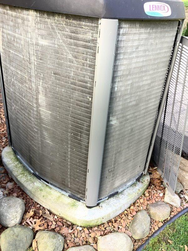 Responded to no cooling complaint on 7-year-old Lennox air conditioning system. Upon arrival, confirmed unit was running but not adequately cooling the residence. Performed complete system diagnostics using calibrated manifold gauges and digital testing equipment. Measured operating pressures and temperatures, recording suction pressure of 72 PSI with superheat readings and discharge pressure of 1359 PSI at outdoor ambient conditions. Temperature readings indicated discharge line temperature of 141°F. 

Inspection of outdoor condensing unit revealed restricted airflow through condenser coil due to accumulated dirt, debris, and biological growth on fins. Noted algae/moss buildup on concrete pad and leaves around unit base indicating maintenance neglect. Condenser coil showed moderate dirt accumulation affecting heat rejection capacity. System analysis confirmed inadequate heat transfer at condenser resulting in elevated head pressures and reduced cooling efficiency.

Cleaned condenser c