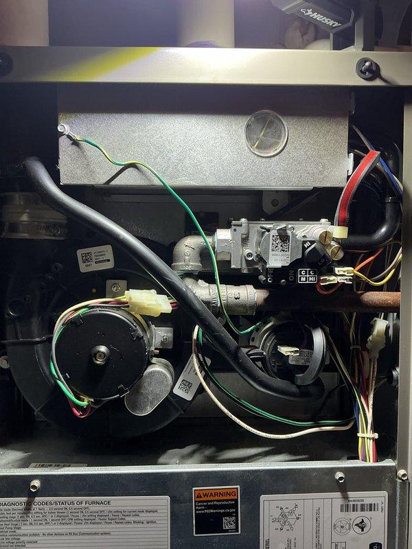 Completed comprehensive AC tune-up on 5-year-old residential cooling system. Performed standard preventive maintenance protocol including inspection of gas valve assembly, blower motor operation, electrical connections, and refrigerant lines. Verified all safety controls, pressure switches, and wiring harnesses functioning properly. Documented equipment condition with interior component photography showing gas valve, blower assembly, and control wiring in satisfactory operating condition. System operating within manufacturer specifications with no immediate repairs required.