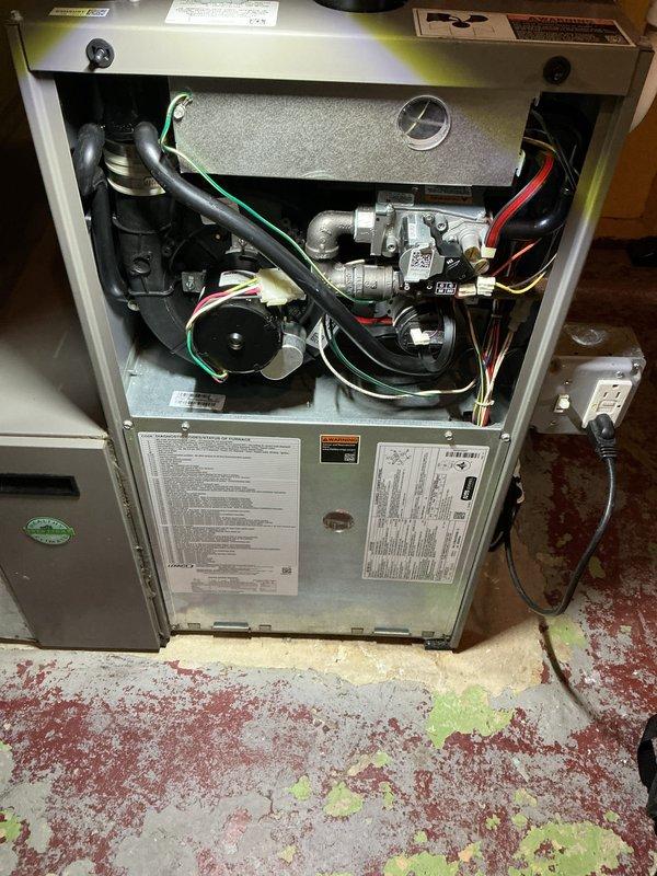 Completed comprehensive AC tune-up on 5-year-old residential cooling system. Performed standard preventive maintenance protocol including inspection of gas valve assembly, blower motor operation, electrical connections, and refrigerant lines. Verified all safety controls, pressure switches, and wiring harnesses functioning properly. Documented equipment condition with interior component photography showing gas valve, blower assembly, and control wiring in satisfactory operating condition. System operating within manufacturer specifications with no immediate repairs required.
