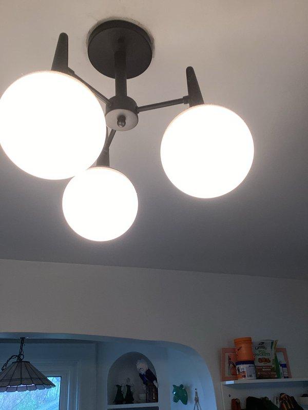 Completed installation of electrical work including a modern three-globe ceiling light fixture with dark metal frame and white spherical glass shades. Verified proper operation of Hoover electrical panel with all circuit breakers functioning correctly and appropriate labeling in place. All fixtures tested and confirmed operational with no permits required for this installation.