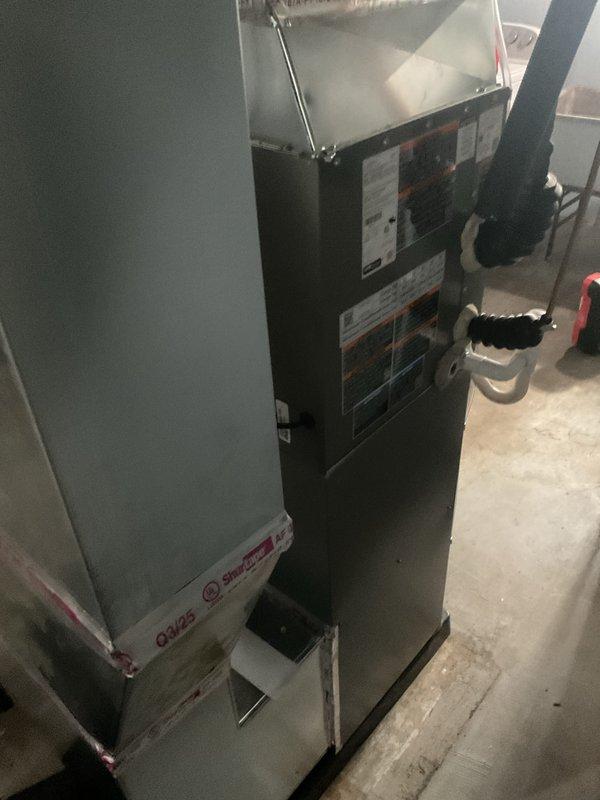 Completed full HVAC system installation including new furnace and air conditioning unit in basement utility area. Installed air handler with proper electrical connections, control box wiring, and mounted all components on secure platform with metal ductwork connections. Configured PVC condensate drainage system with multiple bends and proper routing, connected refrigerant lines with black flexible conduit, and ensured all manufacturer specifications were met per code requirements.