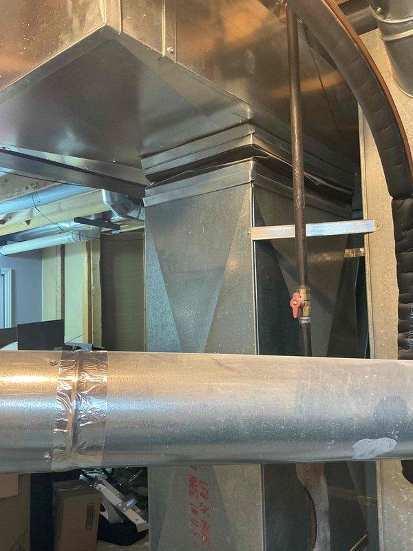 Conducted comprehensive full system HVAC assessment for residential property with 16-year-old air conditioning system requiring replacement within the current season. Evaluated existing Payne brand furnace installation in basement utility area with connected metallic ductwork and assessed overall system configuration including plenum assembly, duct transitions, and insulated refrigerant lines. Documented equipment condition and existing infrastructure through detailed photography to provide accurate replacement system specifications and installation requirements.