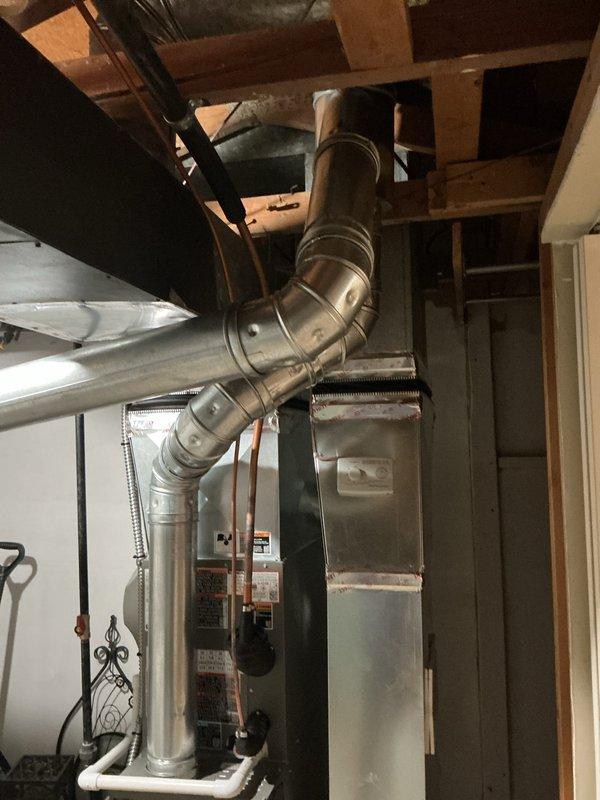 Completed full HVAC system installation in basement utility area, including 70,000 BTU Lennox furnace with humidifier and 2-ton rear-discharge air conditioning unit. Installed all necessary ductwork with galvanized metal supply plenum and flex duct connections, ran copper refrigerant lines between outdoor condenser and indoor air handler, and reconnected all electrical and gas connections per manufacturer specifications. System tested and verified operational with all permits obtained prior to installation.
