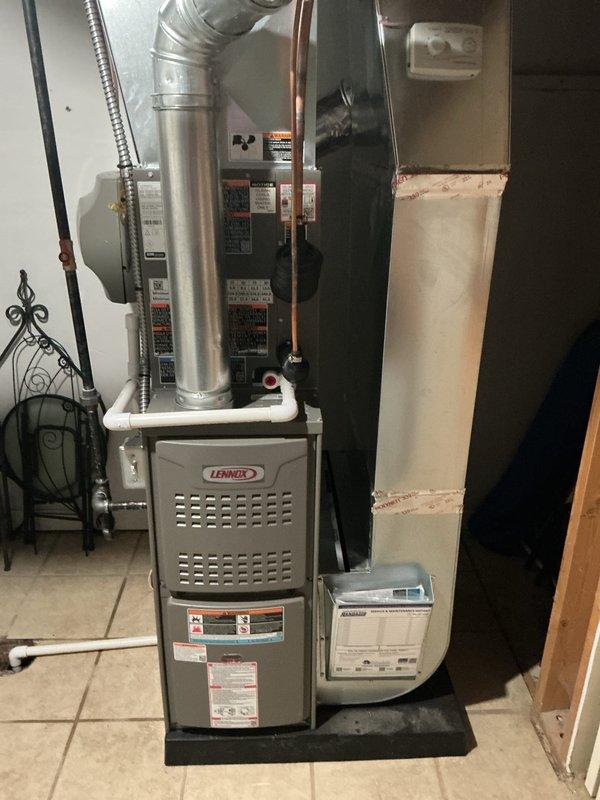 Completed full HVAC system installation in basement utility area, including 70,000 BTU Lennox furnace with humidifier and 2-ton rear-discharge air conditioning unit. Installed all necessary ductwork with galvanized metal supply plenum and flex duct connections, ran copper refrigerant lines between outdoor condenser and indoor air handler, and reconnected all electrical and gas connections per manufacturer specifications. System tested and verified operational with all permits obtained prior to installation.