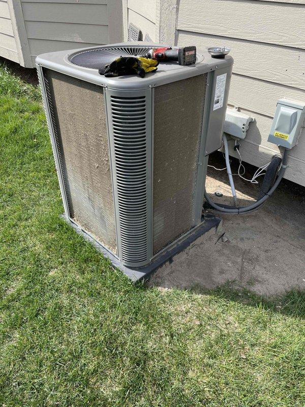 Performed routine air conditioning maintenance on residential outdoor condensing unit. Conducted comprehensive system inspection including cleaning of condenser coils, checking electrical connections at disconnect box, verifying refrigerant line integrity, and testing fan operation. Unit serviced and returned to proper operating condition with all components functioning within manufacturer specifications.