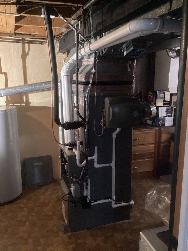 Completed full HVAC system installation in basement mechanical room, including 70,000 BTU furnace and 2.5 ton air conditioning unit with rear discharge configuration. Installed new furnace with PVC intake and exhaust venting, connected ductwork with metallic trunk line, and reconnected all electrical and refrigerant lines to outdoor condensing unit. Permits were obtained prior to installation, system was tested for proper operation, and all work was completed per manufacturer specifications and local mechanical code requirements.