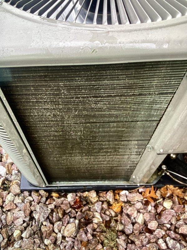 Completed spring maintenance and AC tune-up on a three-year-old central air conditioning system. Inspected outdoor condenser unit and found significant dust and debris accumulation on coil fins, along with scattered insulation material at base requiring cleanup. Performed thorough cleaning of condenser coils to restore proper airflow and heat transfer efficiency, removed debris from unit perimeter, and verified all components are functioning within normal operating parameters.