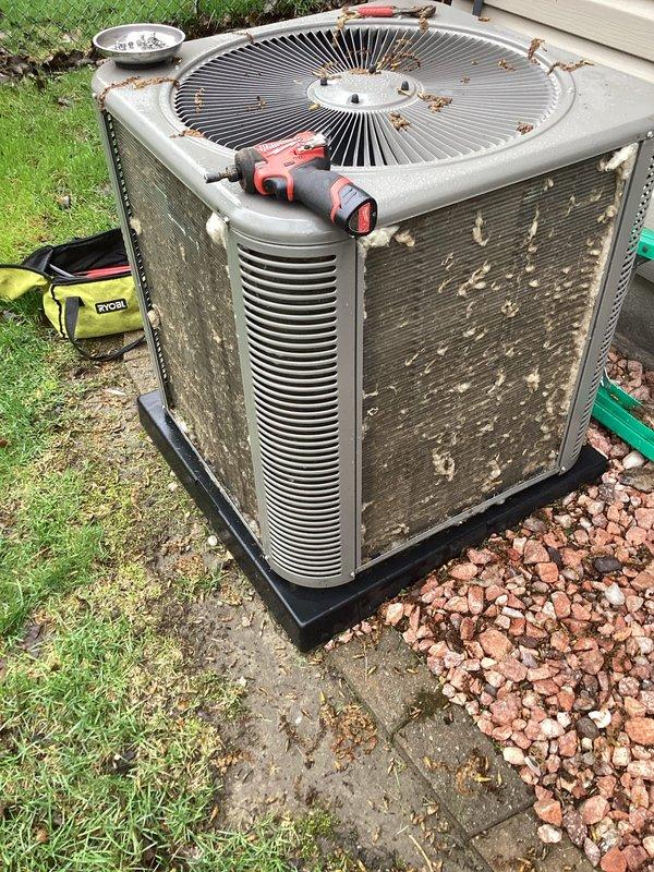 Responded to no-cool complaint on 2.5-year-old residential air conditioning system. Upon arrival, found outdoor condensing unit with heavily soiled condenser coils covered in lint, dust, and fibrous debris, significantly restricting airflow and reducing heat transfer efficiency. Cleaned condenser coils thoroughly to remove accumulated contamination from exterior fins. System restored to proper cooling operation following coil cleaning. Recommended regular maintenance to prevent future airflow restrictions.