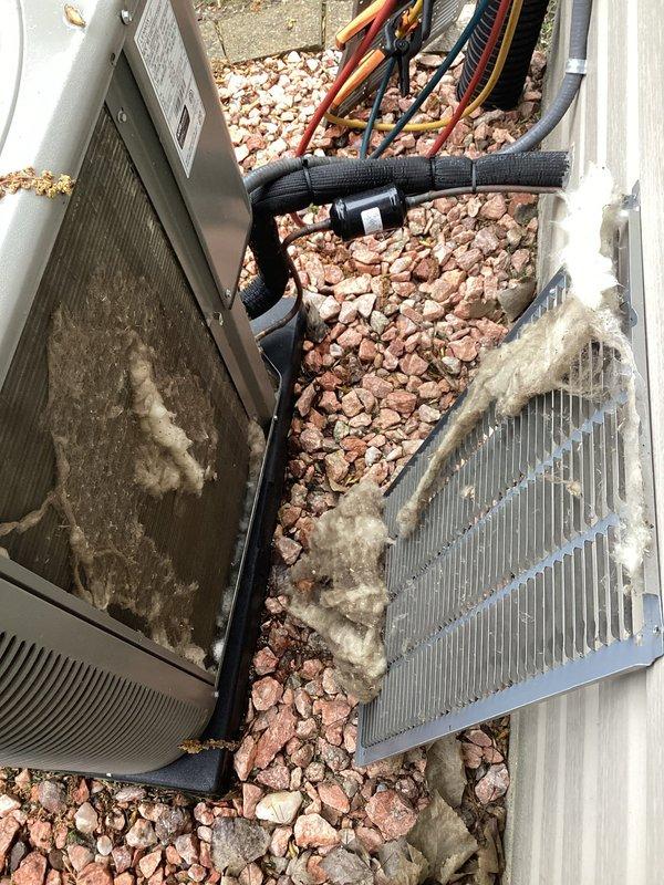 Responded to no-cool complaint on 2.5-year-old residential air conditioning system. Upon arrival, found outdoor condensing unit with heavily soiled condenser coils covered in lint, dust, and fibrous debris, significantly restricting airflow and reducing heat transfer efficiency. Cleaned condenser coils thoroughly to remove accumulated contamination from exterior fins. System restored to proper cooling operation following coil cleaning. Recommended regular maintenance to prevent future airflow restrictions.