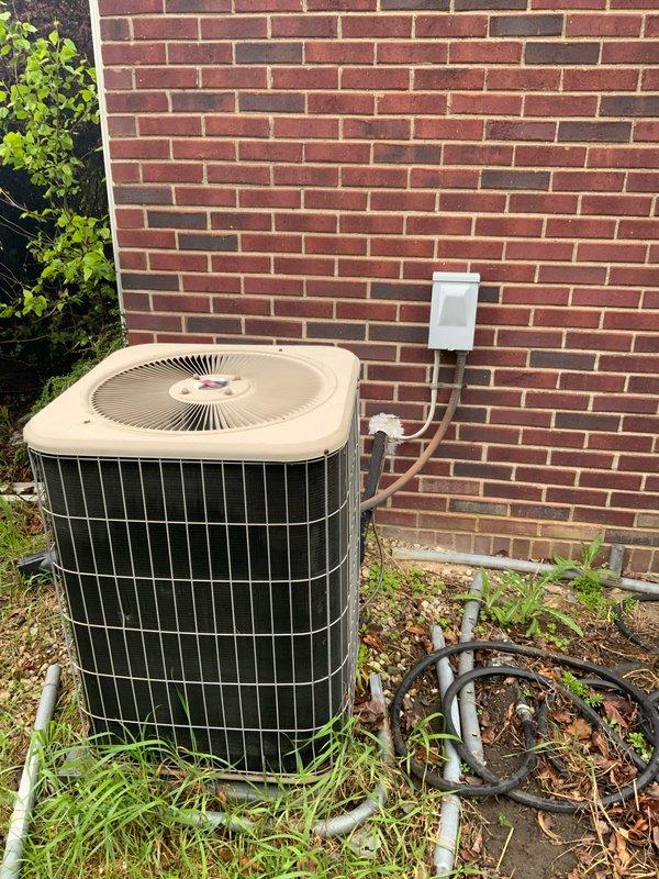 Completed HVAC estimate for cooling system replacement at residential property with medium capacity requirements for 1200-2000 square foot coverage area. Assessed existing outdoor condensing unit positioned against exterior brick wall with copper refrigerant lines and electrical disconnect, along with basement-mounted air handler or furnace system. Provided comprehensive quote for new cooling system installation including equipment specifications, refrigerant line modifications, electrical connections, and integration with existing ductwork infrastructure in basement utility area.