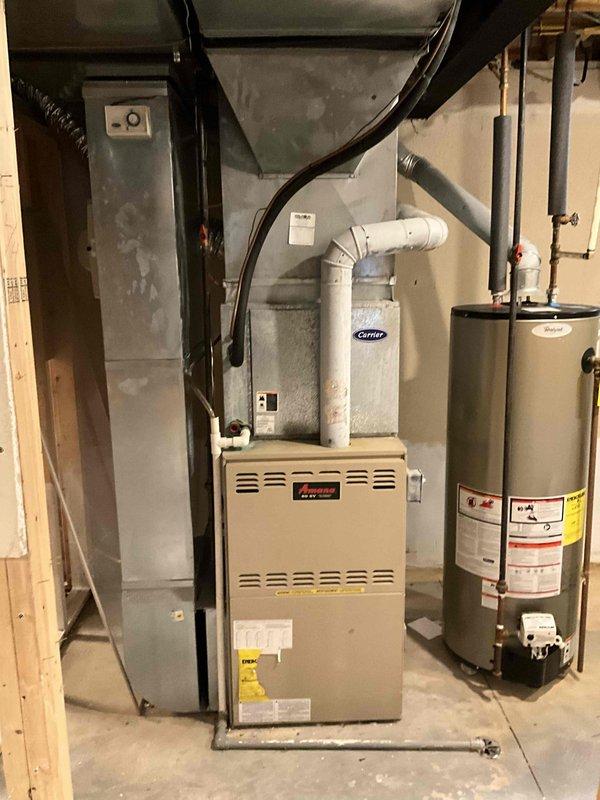 Conducted comprehensive assessment of existing HVAC system in recently purchased residence. Evaluated 16-year-old furnace unit and aging air conditioning system located in basement utility area, documented equipment condition through photographic documentation, and provided full system replacement estimate. Reviewed current installation configuration including PVC venting, ductwork connections, and overall mechanical room layout to develop replacement recommendations for homeowner seeking installation within the next couple weeks.