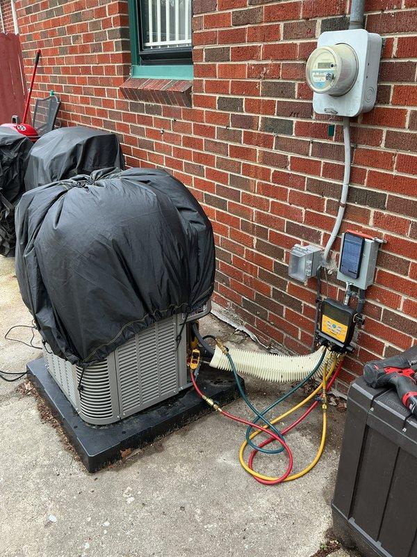 Replaced failed condenser fan motor on residential heat pump system. Connected refrigerant gauges to verify system pressures and temperatures during startup, confirming proper operation with low side reading 110.4 psig and high side reading 302.7 psig. Unit tested and operating within manufacturer specifications.