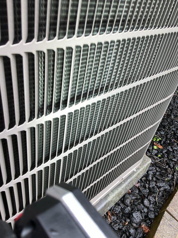Completed routine annual cooling maintenance on residential air conditioning system. Performed comprehensive inspection of outdoor condenser unit, including examination of heat exchanger coil fins which were found to be clean and in good condition with no debris accumulation, corrosion, or damage. Documented unit condition with photographs showing proper fin spacing and structural integrity of coil assembly. System operational and ready for cooling season.