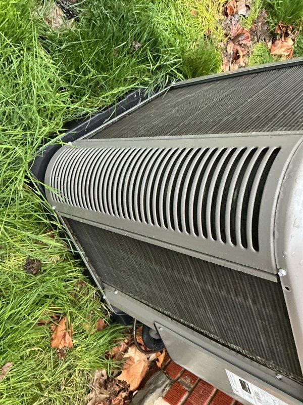 Completed annual cooling maintenance on outdoor condensing unit. Inspected heat exchanger coils, verified fin integrity, and documented mesh screen condition showing typical seasonal debris accumulation. Unit operational with no immediate service requirements identified.