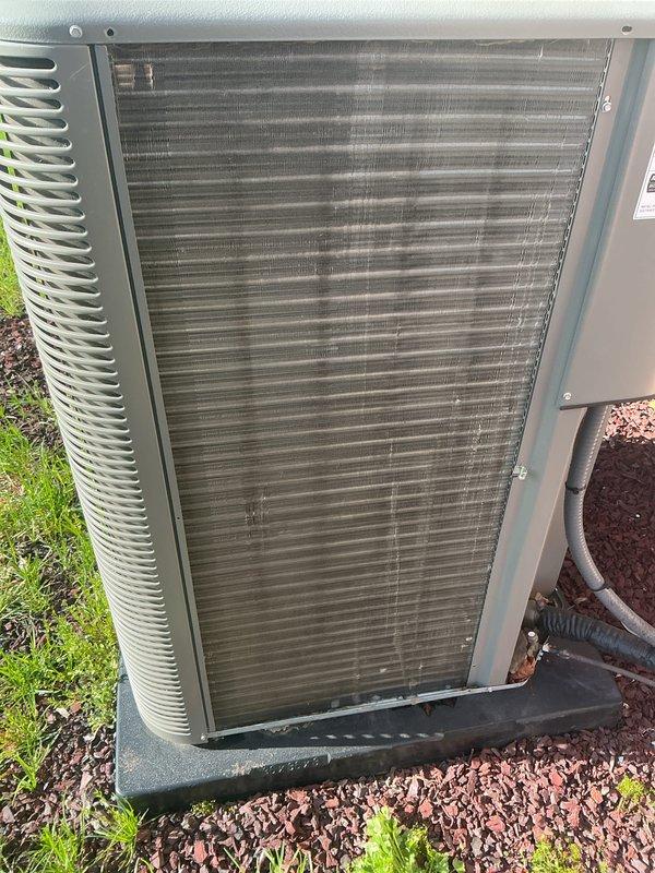 Completed annual HVAC maintenance on residential heating and cooling system. Serviced indoor air handler unit and outdoor condenser unit, addressing multiple inspection points including filter replacement and condenser pad assessment. Documented equipment condition with interior component photography showing blower assembly, control board, electrical connections, and venting system, as well as exterior condenser coil condition requiring attention due to accumulated debris on fins.