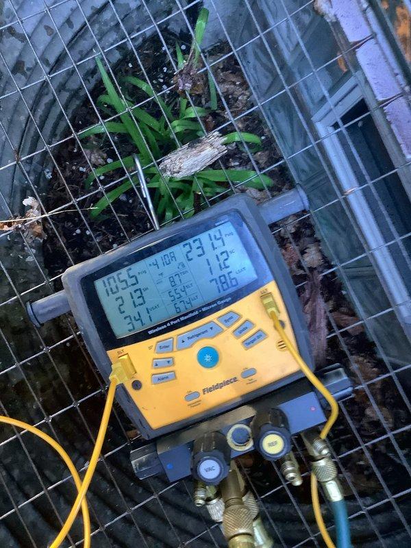 Completed routine Air Care Maintenance on outdoor heat pump unit. Inspected condenser coil which showed significant accumulation of dirt, dust, and debris with visible streaking and discoloration across aluminum fins. Performed system diagnostics using manifold gauges and digital instruments to verify refrigerant pressures and overall system performance.