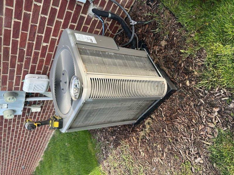 Responded to no cooling complaint on 6-year-old residential air conditioning system located in basement. Upon arrival, performed diagnostic assessment of both indoor and outdoor components. Utilized digital multimeter to test electrical readings and inspect evaporator coil condition. Examined outdoor condenser unit positioned on brick patio, verifying proper operation of compressor and condenser fan motor. Inspected heat exchanger fins for debris accumulation and airflow restrictions. Checked refrigerant lines, electrical connections at disconnect box, and overall system performance. Identified root cause of cooling deficiency and completed necessary repairs to restore proper cooling operation. System tested and verified operational upon completion.