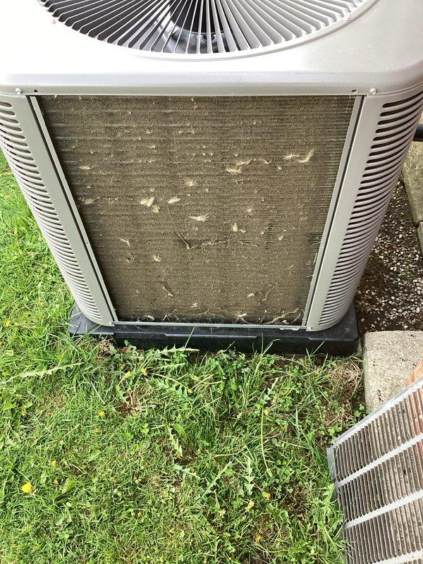 Completed annual cooling maintenance on residential split system air conditioning unit. Performed comprehensive inspection of outdoor condensing unit, which showed significant accumulation of dirt, dust, and debris on condenser coils with visible streaking and contamination patterns indicating extended operation without prior cleaning. Cleaned condenser coils to restore proper airflow and heat transfer efficiency. Inspected fan motor operation, refrigerant line connections, and electrical components. Verified proper unit operation upon completion. System restored to optimal performance standards.