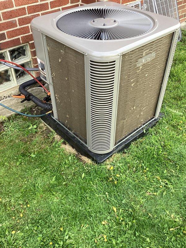 Completed annual cooling maintenance on residential split system air conditioning unit. Performed comprehensive inspection of outdoor condensing unit, which showed significant accumulation of dirt, dust, and debris on condenser coils with visible streaking and contamination patterns indicating extended operation without prior cleaning. Cleaned condenser coils to restore proper airflow and heat transfer efficiency. Inspected fan motor operation, refrigerant line connections, and electrical components. Verified proper unit operation upon completion. System restored to optimal performance standards.