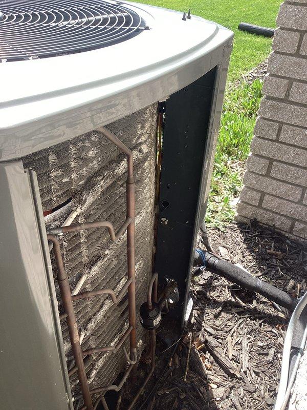 Completed annual cooling maintenance on rooftop zone unit. Performed system diagnostics using manifold gauges to verify refrigerant pressures and temperatures, with readings indicating normal operating parameters. Observed heavily soiled condenser coil with significant accumulation of dirt, dust, and debris restricting airflow. Opened outdoor unit access panel to inspect internal components, noting weathered copper refrigerant lines and clogged coil fins requiring future cleaning attention. System currently operational but would benefit from professional coil cleaning to restore optimal efficiency and heat transfer capability.