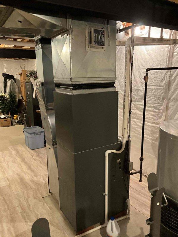 Provided comprehensive estimate for complete HVAC system replacement including natural gas furnace located in basement and outdoor air conditioning condensing unit. Current 10-year-old equipment operational but nearing end of service life. Evaluated existing installation including ductwork connections, PVC condensate drainage, electrical service, and outdoor unit placement on concrete pad with refrigerant lines and conduit routed along exterior brick wall.