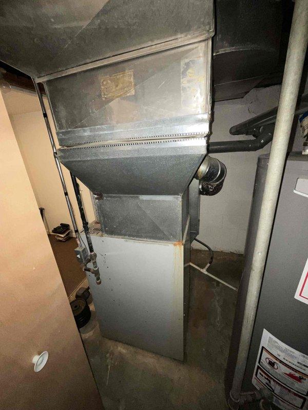 Provided estimate for replacement of 28-year-old furnace and air conditioning system located in basement under BOGO promotion. Current furnace operational but air conditioning unit not functioning. Documented existing HVAC equipment installation including ductwork configuration and basement mechanical room layout for replacement specifications.