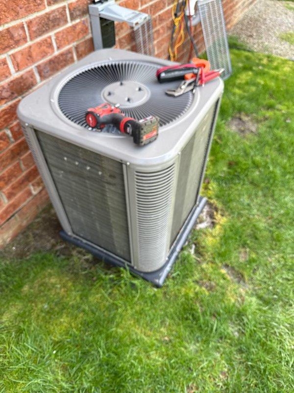 Completed comprehensive air conditioning maintenance inspection on outdoor condenser unit. Performed diagnostic testing using multimeter to verify electrical components, checked voltage and amperage readings, and inspected disconnect box functionality. System operating within normal parameters with no deficiencies observed.