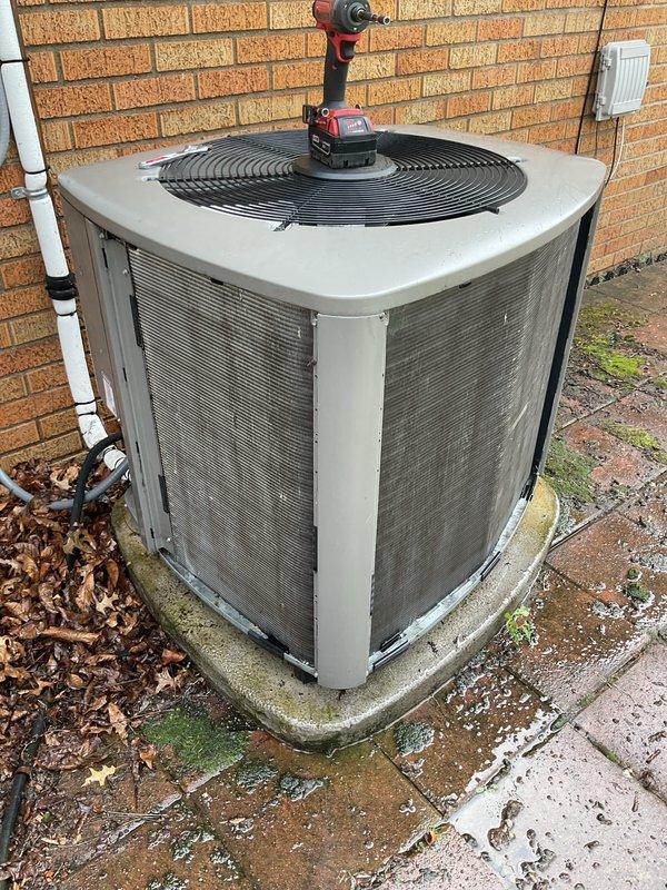 Completed annual cooling maintenance on residential condensing unit. Performed comprehensive inspection of outdoor unit including cleaning of condenser coils, checking refrigerant levels, testing electrical connections, and verifying proper fan motor operation. Unit found in good working condition with normal wear consistent with outdoor exposure. Concrete pad shows moss accumulation but remains structurally sound for equipment support.