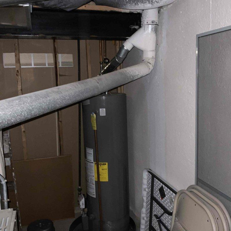 Conducted comprehensive assessment of existing HVAC system in residential single-family home where air conditioning unit was operating inconsistently. Both the air conditioning system and furnace were documented at 25 years of age, well beyond their typical service life expectancy. Evaluated current equipment condition, ductwork configuration, and existing infrastructure in basement utility area. Photographed existing gray metal furnace unit with control panel and connected ductwork, as well as water heater and associated mechanical systems to document current installation layout. Prepared full system replacement estimate for both heating and cooling equipment to address reliability concerns and provide modern, efficient HVAC solution.