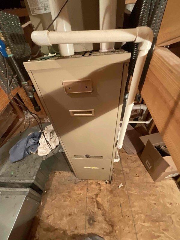 Provided estimate for replacement of two air conditioning units and one furnace in a residential property with equipment located in basement and attic spaces. Assessed existing HVAC systems including attic-mounted air handler with associated ductwork and PVC condensate drainage, noting one furnace was recently replaced while air conditioning units and secondary furnace require replacement due to age. Accessed attic equipment via ladder to evaluate installation conditions and existing duct configurations for proper sizing and equipment recommendations.