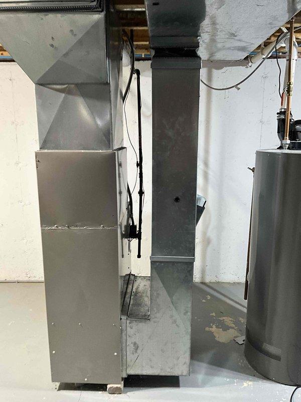 Conducted comprehensive evaluation of 18-year-old Armstrong furnace and air conditioning system in residential basement mechanical room. Assessed existing air handler, ductwork connections, plenum configuration, and overall system condition to provide detailed estimate for complete HVAC system replacement. Documented equipment layout, electrical connections, and existing infrastructure through photographs to support replacement recommendations for new furnace and air conditioner installation.
