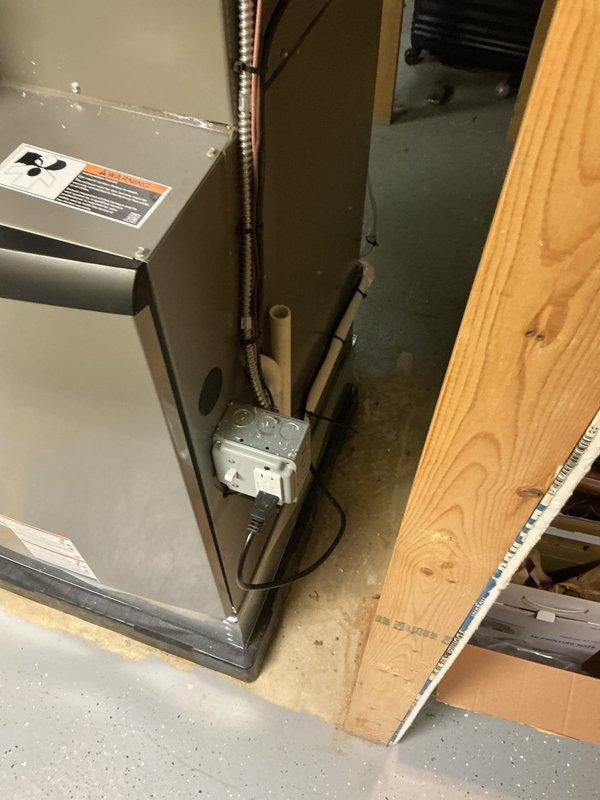 Completed full HVAC system installation including a 135,000 BTU furnace with right-side configuration and 5-ton air conditioning unit in residential mechanical room. Installed PVC condensate drainage lines with proper pitch and connections, reconnected existing humidifier to new furnace, and completed all electrical connections including gas valve wiring. All required mechanical permits were obtained prior to installation, system was tested for proper operation, and installation photos were documented showing furnace placement, drainage piping, and overall system configuration in utility space.