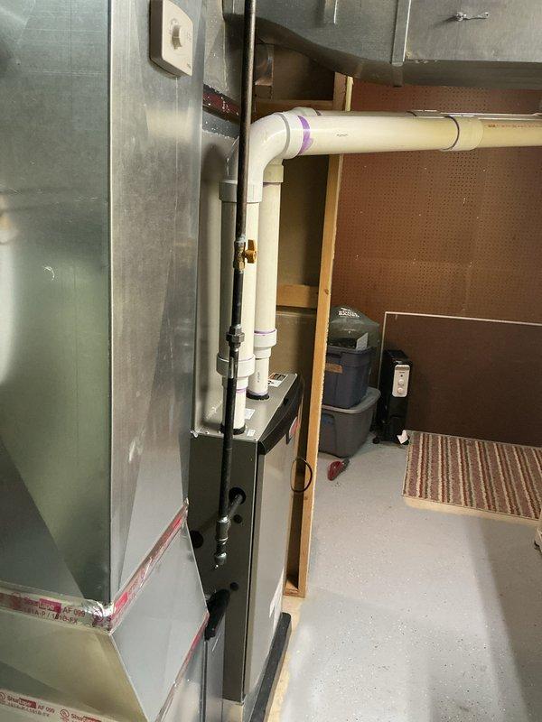 Completed full HVAC system installation including a 135,000 BTU furnace with right-side configuration and 5-ton air conditioning unit in residential mechanical room. Installed PVC condensate drainage lines with proper pitch and connections, reconnected existing humidifier to new furnace, and completed all electrical connections including gas valve wiring. All required mechanical permits were obtained prior to installation, system was tested for proper operation, and installation photos were documented showing furnace placement, drainage piping, and overall system configuration in utility space.