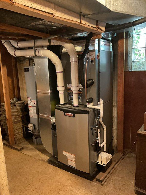 Completed full HVAC system installation including a 90,000 BTU furnace with liner and 3-ton air conditioning unit with rear discharge configuration. Installed new equipment in basement mechanical room with proper venting using white PVC piping, established refrigerant line connections with insulated copper lines routed along exterior siding and brick walls, and completed all electrical reconnections including conduit runs and panel connections. System commissioned and tested for proper operation with utility rebate documentation processed for DTE and Consumers Energy programs.