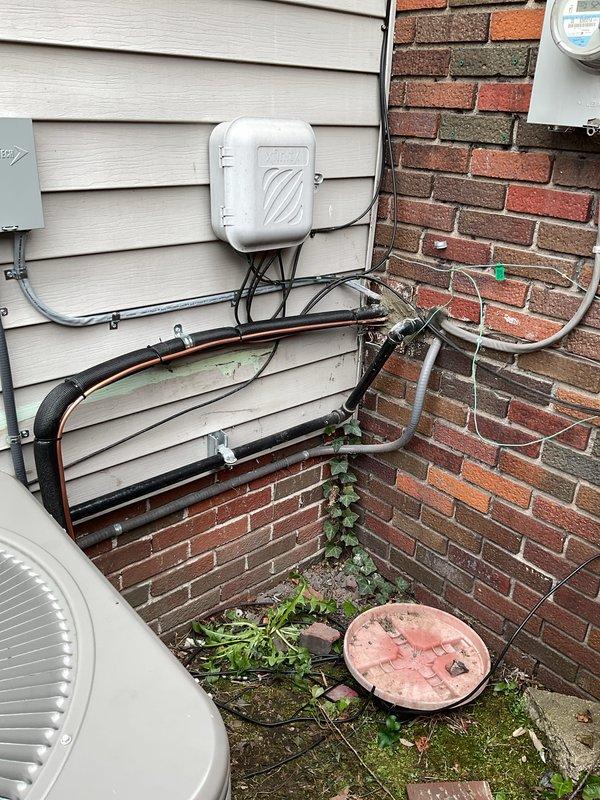 Completed full HVAC system installation including a 90,000 BTU furnace with liner and 3-ton air conditioning unit with rear discharge configuration. Installed new equipment in basement mechanical room with proper venting using white PVC piping, established refrigerant line connections with insulated copper lines routed along exterior siding and brick walls, and completed all electrical reconnections including conduit runs and panel connections. System commissioned and tested for proper operation with utility rebate documentation processed for DTE and Consumers Energy programs.