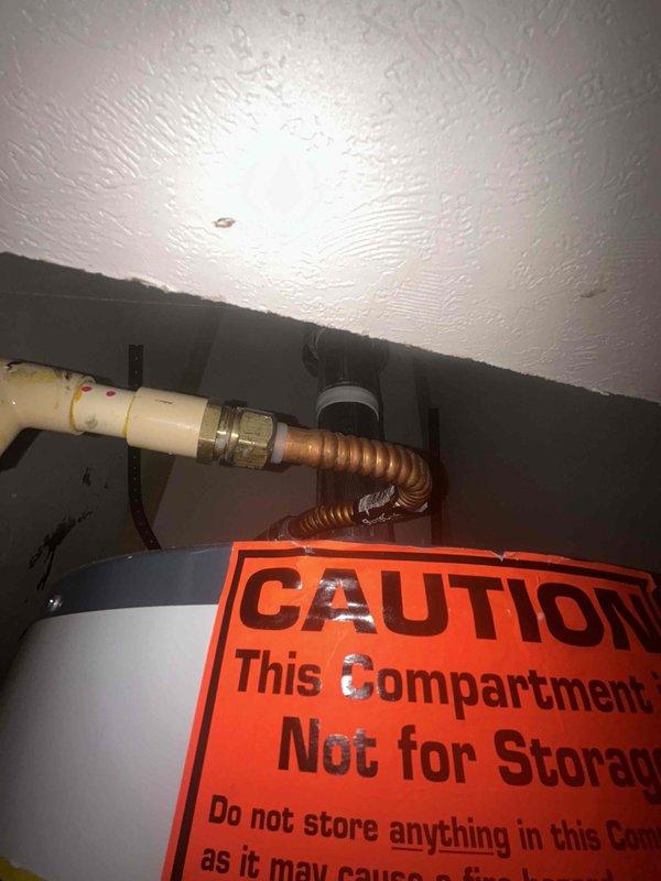 Completed water heater estimate for mobile home installation. Inspected existing Rheem model 21HA02V gas water heater unit located in closet compartment, documented current equipment specifications including serial number and model information, photographed installation area including supply connections with flexible copper corrugated tubing and brass fittings, and assessed replacement requirements for non-operational unit.