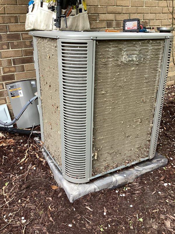 Performed routine annual maintenance on outdoor air conditioning condenser unit. Replaced air filter and evaporator pad as needed. Unit showed normal weathering and surface discoloration but is operating within specifications. Surrounding area cleared of debris and leaves to ensure proper airflow around equipment.